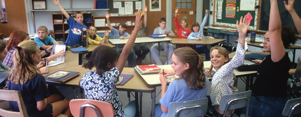 Children at school raising their hands